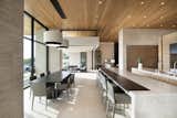 Linear in design, the kitchen sits between the living and great rooms, reinforcing the home's open design. Ideal for casual entertaining, the space includes two quartz-topped islands. Douglas fir ceilings are a warm contrast to limestone walls and floors.

Project Details // Now and Zen
Renovation, Paradise Valley, Arizona
Architecture: Drewett Works
Builder: Brimley Development
Interior Designer: Ownby Design
Photographer: Dino Tonn
Millwork: Rysso Peters
Limestone (Demitasse) flooring and walls: Solstice Stone
Quartz countertops: Galleria of Stone
Windows (Arcadia): Elevation Window & Door
Table: Peter Thomas Designs
Pendants: Hinkley Lighting
Countertops: Galleria of Stone

https://www.drewettworks.com/now-and-zen/