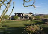 Framed by the Sonoran Desert's distinctive flora, the two-story residence sits on the 11th hole of the No. 7 at Desert Mountain golf course—a USGA-rated championship par-54 course.

The Village at Seven Desert Mountain—Scottsdale
Architecture: Drewett Works
Builder: Cullum Homes
Interiors: Ownby Design
Landscape: Greey | Pickett
Photographer: Dino Tonn

https://www.drewettworks.com/the-model-home-at-village-at-seven-desert-mountain/