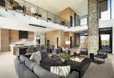 Rich woods, soaring walls and open-concept living define the modern aesthetic of this dynamic desert home. Stained white oak millwork, ledgestone walls and European oak flooring add warmth.

The modular sectional from Kravet and black leather accent chairs surround a custom coffee table by Peter Thomas Designs. 

The Village at Seven Desert Mountain—Scottsdale
Architecture: Drewett Works
Builder: Cullum Homes
Interiors: Ownby Design
Landscape: Greey | Pickett
Photographer: Dino Tonn

https://www.drewettworks.com/the-model-home-at-village-at-seven-desert-mountain/