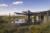 A bird's eye view of the wings and negative-edge pool beneath The Crusader, designed to honor architect C.P. Drewett's Marine Corps aviator father and his plane, the F8.

Estancia Club
Builder: Peak Ventures
Interiors: Ownby Design
Landscape: High Desert Designs
Photography: Jeff Zaruba