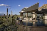 The lot, located in the prestigious Estancia Golf Club community, sits on a peninsula, highly exposed on three sides yet with tremendous views. The negative edge hot tub and pool create a patio island.

Estancia Club
Builder: Peak Ventures
Interior Design: Ownby Design
Landscape: High Desert Designs