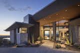 The entry offers an invitation to view the spectacular city and mountain views beyond. Cedar ceilings and overhangs, large format porcelain panel cladding, and split-faced silver travertine provide a warm and textured material palette. A pivot glass door welcomes guests.

Estancia Club
Builder: Peak Ventures
Landscape: High Desert Designs
Interior Design: Ownby Design
Photography: Jeff Zaruba