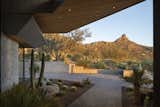 Specimen cactus, Cedar overhangs, and a custom-finish standing seam metal roof system frame the view of Pinnacle Peak at the entry of The Crusader.

Estancia Club
Builder: Peak Ventures
Landscape: High Desert Designs
Photography: Jeff Zaruba