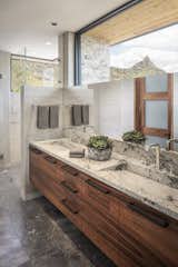 Clerestory windows frame Pinnacle Peak mountain views. Macassar Ebony cabinets are topped with integrated Cartier Quartzite sinks and Hansgrohe fixtures.

Estancia Club
Builder: Peak Ventures
Interior Design: Ownby Design
Photography: Jeff Zaruba