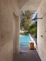 Travertine-clad outdoor shower.