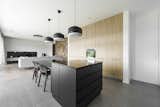 Kitchen, Pendant Lighting, Wood Cabinet, Wall Oven, Colorful Cabinet, and Concrete Floor  Photo 11 of 11 in BLACK BOX HOUSE by PAOArchitects