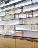 A combination of clear and translucent glass on steel shelves.