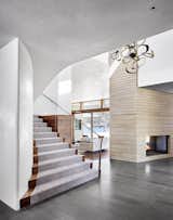 A unique scissor-like stair that stitches the first and second floors together from both sides of the house.