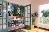 French doors lead to a peaceful deck space for outdoor dining