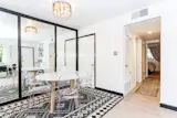 Lucite ghost chairs in dining room.