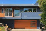 A closer view of the shou sugi ban siding, cedar faced garage door and cement fiber panels.