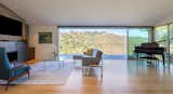 Large sliding door opening up to an exterior deck and nature preserve beyond.