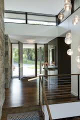 Hallway, Medium Hardwood Floor, and Limestone Floor  Photo 6 of 15 in Sunfish Lake Residence by PKA Architecture