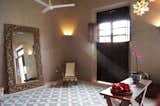 The living room is filled with natural light. The traditional pasta tiles give texture to the floor.
