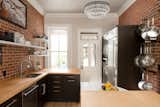 Kitchen, Wood Cabinet, Wood Counter, Marble Counter, Pendant Lighting, Refrigerator, Wall Oven, Brick Backsplashe, Microwave, and Undermount Sink Built-in refrigerator, microwave, warming drawer, and a toaster cubby  Photo 5 of 7 in Historic Kitchen Remodel by Kimball Modern