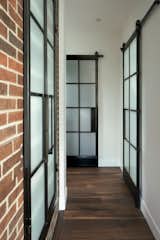 Hallway and Dark Hardwood Floor  Photo 15 of 17 in Brick House by Kimball Modern