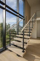 Staircase, Wood Tread, Glass Railing, and Metal Railing Thick White Oak Stair Treads with Glass Railings.  Photos from Montauk Party House
