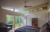 Bedroom, Bed, Bookcase, Chair, Ceiling Lighting, and Medium Hardwood Floor The master bedroom enjoys south facing windows.  Photo 13 of 16 in Dogtrot at Stony Point by hays+ewing design studio