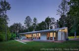 Outdoor, Back Yard, Grass, Trees, Small Patio, Porch, Deck, and Concrete Patio, Porch, Deck Evening view.  The owner co-habitate with turkey, fox and other wildlife which they enjoy from the dogtrot terrace.  Photo 14 of 16 in Dogtrot at Stony Point by hays+ewing design studio