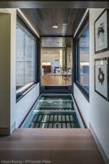 A glass bridge spans over the entry.  View through to upper porch.