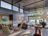 Living room and fireplace.  Materials include concrete and limestone floor, ebony stained wood at walls and ceiling.  Windows are triple pane by Optiwin.  Fireplace is ethanol burning by Ecosmart Fire.  Decor by DaMotto Design.