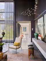 Large sliding glass doors separate the kitchen from dining room when entertaining.  Bypass doors are custom laminated with artwork by Eros Zhao.  Interiors by DaMotta Design.