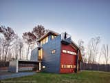Moon viewing balcony.  Roof folds up and over the house to gather interior spaces within its quirky form.  Playful window shapes.  Third floor mediation room also serves as a solar chimney.