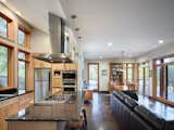 Kitchen, Granite Counter, Refrigerator, Wall Oven, Wood Cabinet, Medium Hardwood Floor, Pendant Lighting, Stone Slab Backsplashe, Cooktops, and Drop In Sink  Photo 9 of 16 in Stony Point House by hays+ewing design studio