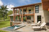 Outdoor, Trees, Grass, Back Yard, Small Pools, Tubs, Shower, Stone Patio, Porch, Deck, Hanging Lighting, and Large Patio, Porch, Deck  Photo 9 of 9 in Leaning Timber House by Archer & Buchanan Architecture