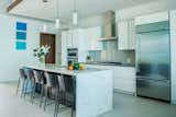 Kitchen, White Cabinet, Subway Tile Backsplashe, Porcelain Tile Floor, Pendant Lighting, Refrigerator, Cooktops, Marble Counter, and Drop In Sink  Photos from Tip of the Tail Villa