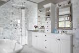 Marble Counter, Drop In Sink, Freestanding Tub, Wall Lighting, Enclosed Shower, and Marble Wall  Photo 15 of 18 in Contemporary Craftsman on the Water by Kati Curtis Design
