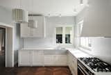 Kitchen, White, Medium Hardwood, Marble, Marble, Ceiling, Drop In, Dishwasher, and Refrigerator buda_kitchen  Kitchen Marble White Ceiling Dishwasher Photos from buda
