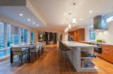 Kitchen, Light Hardwood Floor, Range Hood, Wood Cabinet, and Porcelain Tile Backsplashe  Photos from Solon Residence