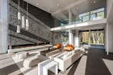 Living Room, Pendant Lighting, Ceiling Lighting, Sofa, Gas Burning Fireplace, Chair, and Light Hardwood Floor  Photo 3 of 12 in Bentleyville Residence by Dimit Architects