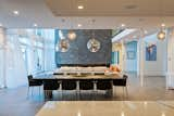 Dining Room, Light Hardwood Floor, Ceiling Lighting, Gas Burning Fireplace, Pendant Lighting, and Table  Photo 5 of 12 in Bentleyville Residence by Dimit Architects