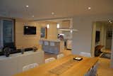 White Cabinet, Recessed Lighting, Wood Cabinet, Light Hardwood Floor, Engineered Quartz Counter, Pendant Lighting, Range, Range Hood, Table, Stools, Bar, Chair, Living Room, and Console Tables Living/Dining looking toward Kitchen  Photo 4 of 7 in Eiderdown