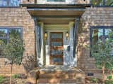 The front door with oversized stoop with wingwalls 