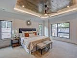 Master bedroom with wood inlayed tray ceiling and LED uplighting