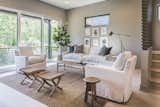 Living room with triple sliding doors opening to a balcony with custom designed metal railing. 