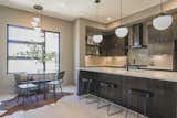 Kitchen with breakfast area, open shelving, and dine-in island