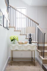 The entry showcases a rustic reclaimed wood staircase, with simple steel uprights. 