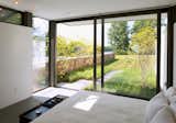 A guest suite with bath and changing areas has a large sliding door out to a private garden.