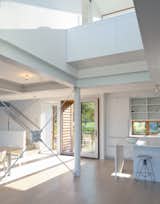A view back to the front door and kitchen.  The desk is above in the double height space.