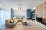 Living Room, Ceiling Lighting, Sofa, Corner Fireplace, Coffee Tables, Bookcase, and Light Hardwood Floor  Photo 1 of 11 in From Sky to Sea by Razvan Barsan + Partners