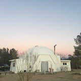 Geodesic dome floats above a pink sunset the round shape pleasing to the eye and fitting with natural surroundings   Photo 1 of 4 in Zen Dome Joshua Tree by Angel Chen