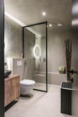 Bath Room, Concrete Floor, Vessel Sink, Laminate Counter, Open Shower, Accent Lighting, Ceiling Lighting, Concrete Wall, and One Piece Toilet  Photos from sh5