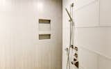 The master bathroom floor tiles is also carried vertically on the end walls and in the shower. 