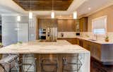The kitchen features Cambria quartz countertops and a custom finish on the cabinetry. 