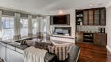 The living room focal wall features a recessed fireplace, custom surround, and new media cabinetry. 