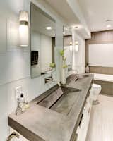 The master bathroom features a custom concrete countertop with integrated trough sinks.